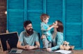 Family cares about education of their son. Parents teaches son, chalkboard on background. Homeschooling concept. Parents