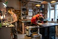 Family carpentry workshop. Busy spouses of carpenters working on wood in joinery.