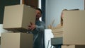 Family carrying cardboard boxes to new apartment. Couple excited by moving. Royalty Free Stock Photo