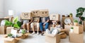 Family in carton boxes on heads in new apartment