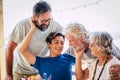 Family caucasian portrait of happy cheerful family with three generations from grandson to son and grandfathers all together