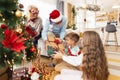 Grandparents giving presents to grandchildren on Christmas day