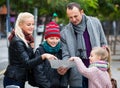 Family checking direction in map Royalty Free Stock Photo