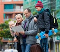 Family checking direction in map Royalty Free Stock Photo