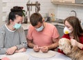 Family checking temperature during COVID-19 pandemic at home