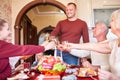 Family cheering and drinking on Thanksgiving on a blurred background. Family holiday gathering concept. Royalty Free Stock Photo