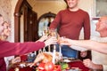 Family cheering and drinking on Thanksgiving on a blurred background. Family holiday gathering concept. Royalty Free Stock Photo