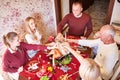 Family cheering and drinking on Thanksgiving on a blurred background. Family holiday gathering concept. Royalty Free Stock Photo