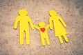 Family with a child cut out of yellow paper. Love and care. Royalty Free Stock Photo