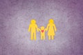 Family with a child cut out of yellow paper. Love and care. Royalty Free Stock Photo