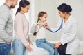 Family with child girl visiting doctor woman at clinic office. Royalty Free Stock Photo