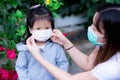 Family and child girl wear medical face masks outside the home or park. Mother and daughter wearing mask during flu coronavirus Royalty Free Stock Photo