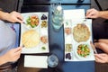 Family with child having traditional Israeli breakfast in the morning in cafe. Each portion with Eggs omelet, vegetable salad, sna