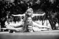 Family and child outdoors in spring nature. Fly concept, little boy is sitting pickaback while imitating the flight