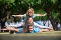 Family and child outdoors in spring nature. Fly concept, little boy is sitting pickaback while imitating the flight