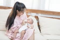 Family, child and parenthood concept - happy beautiful young asian mother smiling hugging holding newborn baby in her arms and Royalty Free Stock Photo