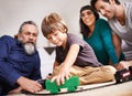 Family, child and play with floor, train and toy in home or house with joy. Woman, kid and men for smile, youth and Royalty Free Stock Photo