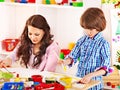 Family with child playing bricks.