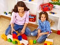 Family with child playing bricks.