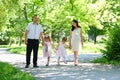 Family with child and pregnant woman walk in summer city park Royalty Free Stock Photo