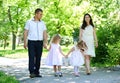 Family with child and pregnant woman walk in summer city park Royalty Free Stock Photo