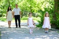 Family with child and pregnant woman walk in summer city park Royalty Free Stock Photo