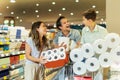 Family with child and shopping cart buying food at grocery store or supermarket Royalty Free Stock Photo