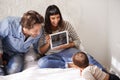 Family, child and toddler for video call in bedroom, internet and happy for grandparents on screen. Parents, baby and Royalty Free Stock Photo