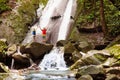 Family with child at waterfall. Travel with kids