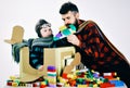 Family and childhood concept. Son and dad play with colorful plastic blocks. Father and child spend time together.