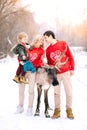 Family, childhood, season, holidays and people concept happy family in winter clothes over lights background Royalty Free Stock Photo