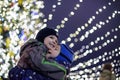 Family, childhood, season and people concept - happy in winter clothes over snowy city background Royalty Free Stock Photo