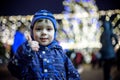 Family, childhood, season and people concept - happy in winter clothes over snowy city background Royalty Free Stock Photo