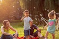 Family with children blow soap bubbles in park Royalty Free Stock Photo