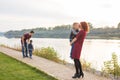 Family and children concept - mother, father and two sons enjoying the summer time, playing near the river Royalty Free Stock Photo