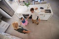 Family, children and dance with a girl and her parents dancing together in the kitchen of their home. Smile, fun and Royalty Free Stock Photo