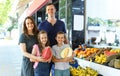 Family with children demostration fresh fruits