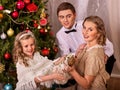 Family with children dressing Christmas tree. Royalty Free Stock Photo