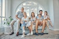 Family, children and grandparents with a man, woman and grandkids sitting on a sofa in the home living room together