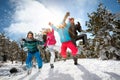 Family with children high jump on winter day on ski vacation and