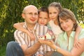 Family with children keeping wendy house in hands