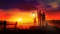 Family with children launches a Chinese lantern at sunset Royalty Free Stock Photo