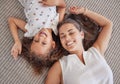 Family, children and love above a girl and mother lying on a bed in the bedroom of their home together from above. Kids Royalty Free Stock Photo