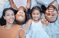 Family, children and love with a mother, father and girl siblings lying on the ground together from above. Kids, floor Royalty Free Stock Photo