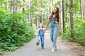 Family, children and nature concept - Portrait of attractive woman and little child girl walking together Royalty Free Stock Photo