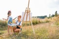 family, children and people concept - happy mother and daughter drawing and talking over green background. Mother& x27;s Royalty Free Stock Photo