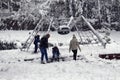 Family with children play and have fun in snow