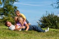 Family with children playing on a meadow Royalty Free Stock Photo