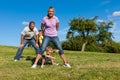 Family with children playing on a meadow Royalty Free Stock Photo