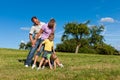 Family with children playing on a meadow Royalty Free Stock Photo